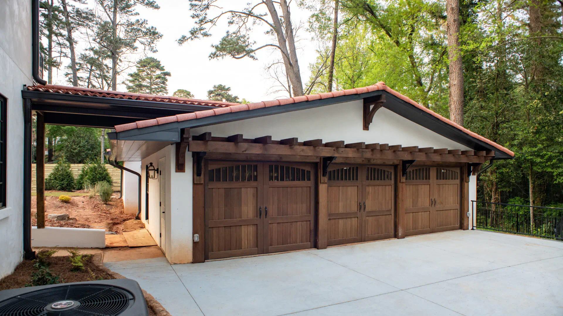 garage with three wooden garage doors